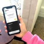 A smartphone with the Powerswitch New Zealand app open, showing a clear and user-friendly interface for comparing standard and new time-of-use plans for electricity.