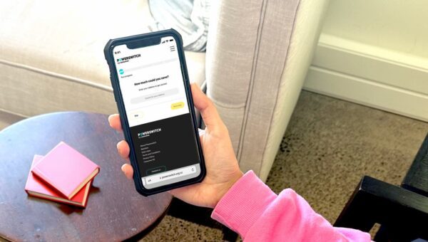 A smartphone with the Powerswitch New Zealand app open, showing a clear and user-friendly interface for comparing standard and new time-of-use plans for electricity.