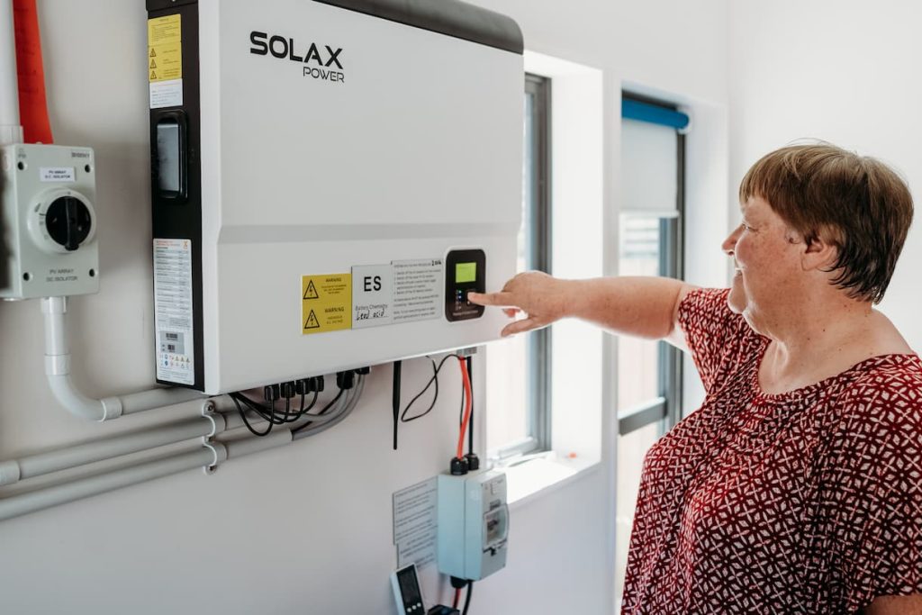 Electric Kiwi customer Anne from Christchurch using her home solar battery storage system for renewable energy in New Zealand